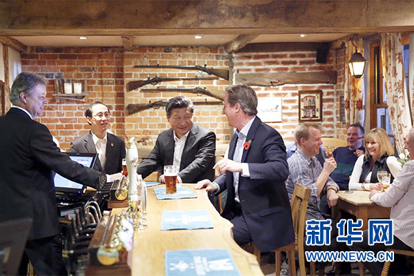 這是會(huì)晤結(jié)束后，習(xí)近平在卡梅倫陪同下乘車前往當(dāng)?shù)匦℃?zhèn)體驗(yàn)酒吧文化。新華社記者 鞠鵬 攝